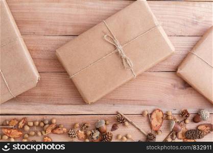 autumn background. cones,acorns and pieces of wood with a Packed parcel on a wooden background. the view from the top.