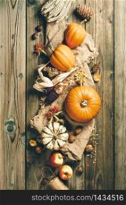 Autumn background - fallen leaves and healthy food on old wooden table. Thanksgiving day concept. Autumn background. Thanksgiving, harvest, halloween concept flat lay top view