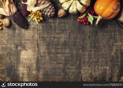 Autumn background - fallen leaves and pumpkins on old wooden table. Thanksgiving day concept. Autumn background - fallen leaves and pumpkins on old wooden table.