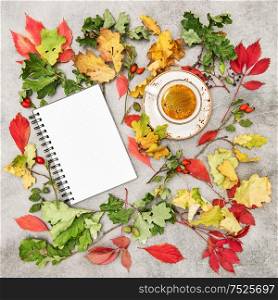 Autumn background flat lay. Notebook and cup of coffee