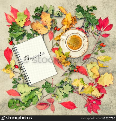 Autumn background flat lay. Notebook and cup of coffee. September. Vintage style toned picture