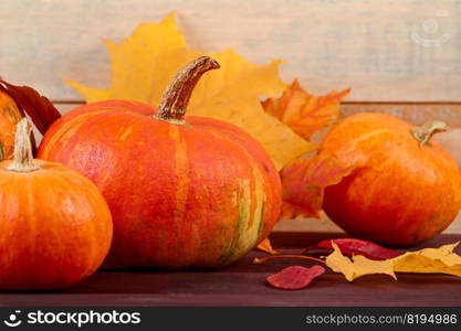 Autumn background. Ripe pumpkins and yellow fallen leaves. Harvest and Thanksgiving concept. Halloween celebrations. Copy space.. Autumn background. Ripe pumpkins and yellow fallen leaves. Harvest and Thanksgiving concept. Halloween celebrations.