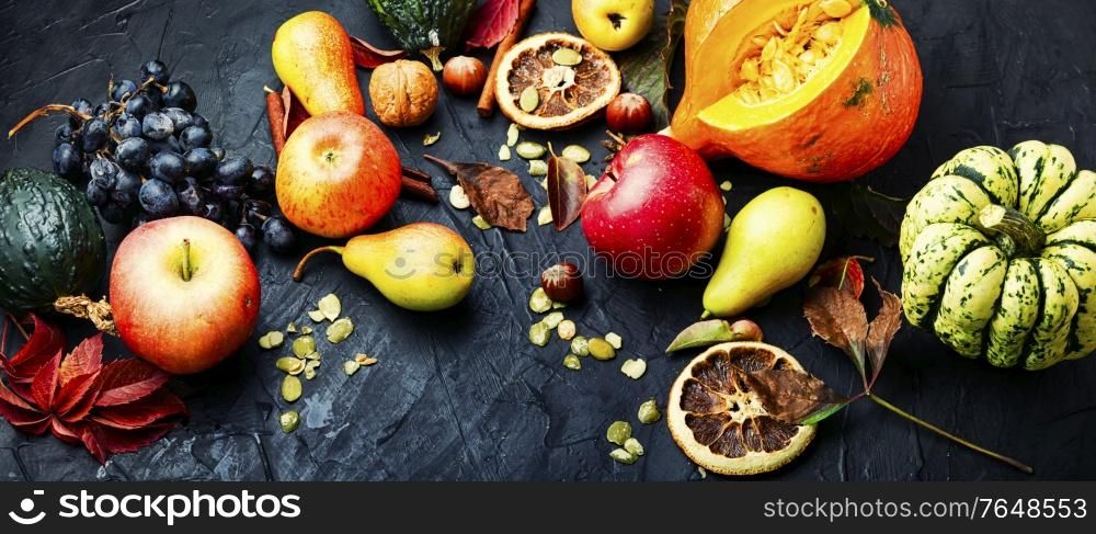 Autumn background with seasonal autumn fruit,pumpkins and nuts.Autumn nature concept.Autumn still life. Autumn harvest background
