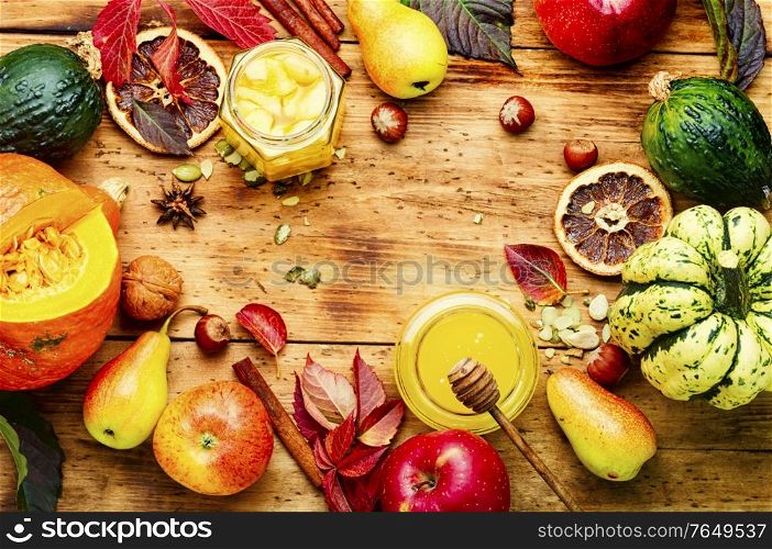 Autumn background with seasonal autumn fruit,pumpkins and nuts.Autumn nature concept.Autumn still life. Autumn harvest background