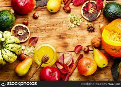 Autumn background with seasonal autumn fruit,pumpkins and nuts.Thanksgiving autumn background.Copy space. Autumn harvest background