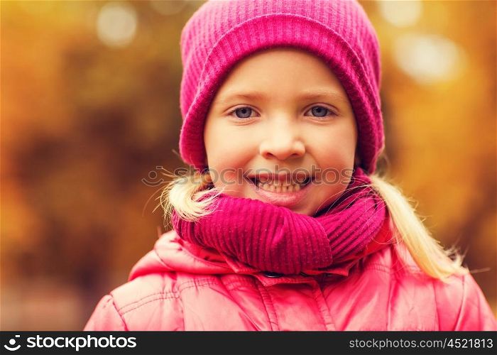 autumn, childhood, happiness and people concept - happy beautiful little girl portrait outdoors