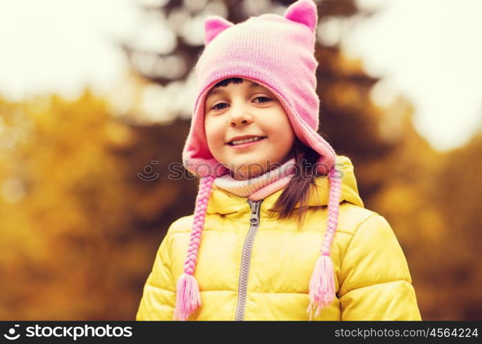 autumn, childhood, happiness and people concept - happy beautiful little girl portrait outdoors