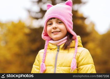 autumn, childhood, happiness and people concept - happy beautiful little girl portrait outdoors