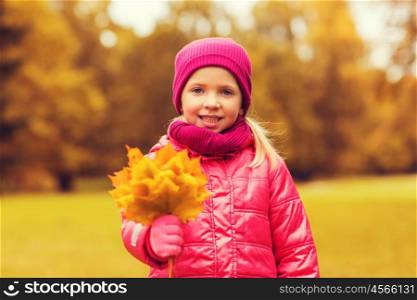 autumn, childhood, happiness and people concept - happy beautiful little girl with maple leaves bunch outdoors
