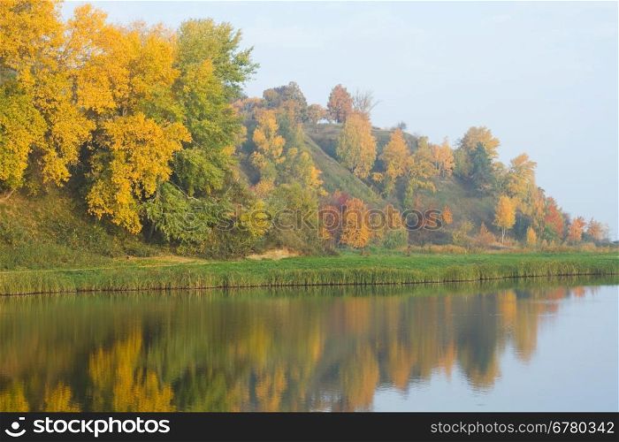 Autumn colorful foliage over lake