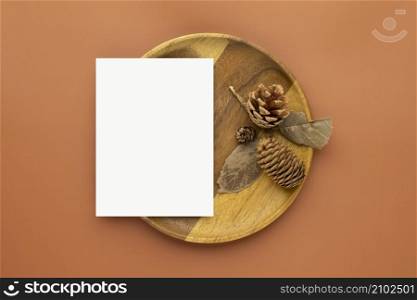 Autumn composition, Blank paper cards Mockup with dried leaves. and pine cones on brown background. Flat lay, top view with copy space