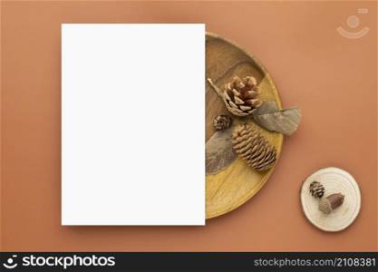 Autumn composition, Blank paper cards Mockup with dried leaves. and pine cones on brown background. Flat lay, top view with copy space