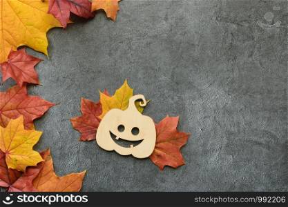 Autumn composition. Red snd orange Maple leaves and decorative pumpkin. Helloween. Flat lay, top view. Copyspace. Autumn composition. Maple leaves and decorative pumpkin. Flat lay, top view