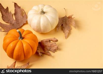 Autumn composition with creative top view autumn leaves and mini pumpkins.