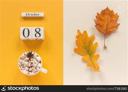 Autumn composition. Wooden calendar Octobe 8, cup of cocoa with marshmallows and yellow autumn leaves on yellow beige background. Top view Flat lay Mockup Concept Hello September.. Autumn composition. Wooden calendar October 8, cup of cocoa with marshmallows and yellow autumn leaves on yellow beige background. Top view Flat lay Mockup Concept Hello September
