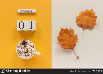 Autumn composition. Wooden calendar October 1, cup of cocoa with marshmallows and yellow autumn leaves on yellow beige background. Top view Flat lay Mockup Concept Hello September.. Autumn composition. Wooden calendar October 1, cup of cocoa with marshmallows and yellow autumn leaves on yellow beige background. Top view Flat lay Mockup Concept Hello September