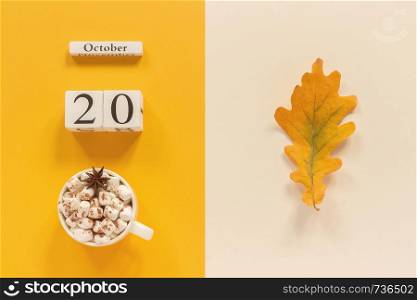 Autumn composition. Wooden calendar October 20 , cup of cocoa with marshmallows and yellow autumn leaves on yellow beige background. Top view Flat lay Mockup Concept Hello September.. Autumn composition. Wooden calendar October 20, cup of cocoa with marshmallows and yellow autumn leaves on yellow beige background. Top view Flat lay Mockup Concept Hello September