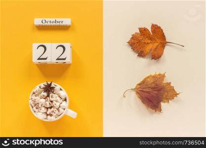 Autumn composition. Wooden calendar October 22 , cup of cocoa with marshmallows and yellow autumn leaves on yellow beige background. Top view Flat lay Mockup Concept Hello September.. Autumn composition. Wooden calendar October 22, cup of cocoa with marshmallows and yellow autumn leaves on yellow beige background. Top view Flat lay Mockup Concept Hello September