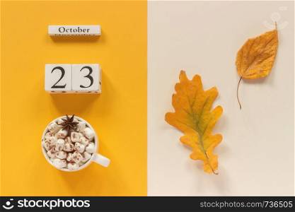 Autumn composition. Wooden calendar October 23 , cup of cocoa with marshmallows and yellow autumn leaves on yellow beige background. Top view Flat lay Mockup Concept Hello September.. Autumn composition. Wooden calendar October 23, cup of cocoa with marshmallows and yellow autumn leaves on yellow beige background. Top view Flat lay Mockup Concept Hello September