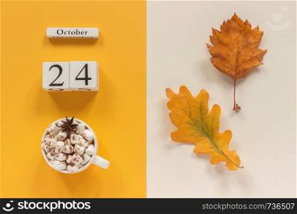 Autumn composition. Wooden calendar October 24, cup of cocoa with marshmallows and yellow autumn leaves on yellow beige background. Top view Flat lay Mockup Concept Hello September.. Autumn composition. Wooden calendar October 24, cup of cocoa with marshmallows and yellow autumn leaves on yellow beige background. Top view Flat lay Mockup Concept Hello September