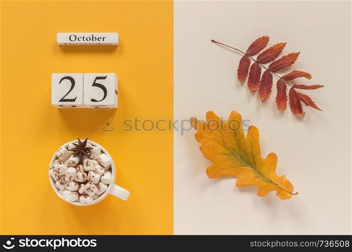 Autumn composition. Wooden calendar October 25, cup of cocoa with marshmallows and yellow autumn leaves on yellow beige background. Top view Flat lay Mockup Concept Hello September.. Autumn composition. Wooden calendar October 25, cup of cocoa with marshmallows and yellow autumn leaves on yellow beige background. Top view Flat lay Mockup Concept Hello September