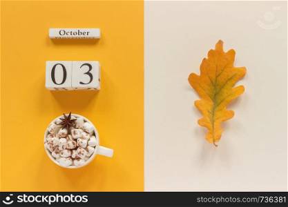 Autumn composition. Wooden calendar October 3 , cup of cocoa with marshmallows and yellow autumn leaves on yellow beige background. Top view Flat lay Mockup Concept Hello September.. Autumn composition. Wooden calendar October 3, cup of cocoa with marshmallows and yellow autumn leaves on yellow beige background. Top view Flat lay Mockup Concept Hello September