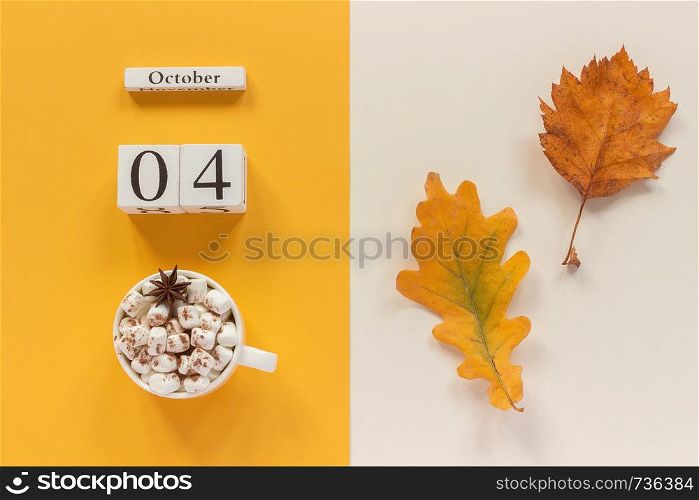 Autumn composition. Wooden calendar October 4, cup of cocoa with marshmallows and yellow autumn leaves on yellow beige background. Top view Flat lay Mockup Concept Hello September.. Autumn composition. Wooden calendar October 4, cup of cocoa with marshmallows and yellow autumn leaves on yellow beige background. Top view Flat lay Mockup Concept Hello September