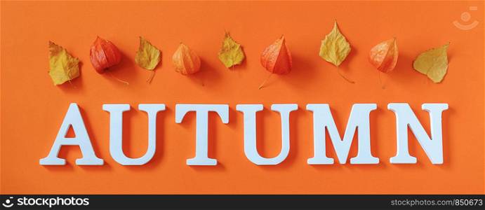 Autumn composition. Word Autumn from white letters and bright autumn leaves herbarium on orange paper background. Concept Hello fall. Creative Top view Flat lay Banner.. Autumn composition. Word Autumn from white letters and bright autumn leaves herbarium on orange paper background. Concept Hello fall. Creative Top view Flat lay Banner