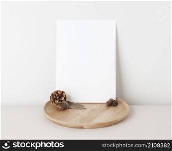 Autumn concept, Blank paper cards Mockup with dried leaves. and pine cones on beige background with copy space