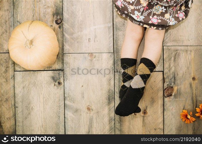 autumn concept with legs girl pumpking