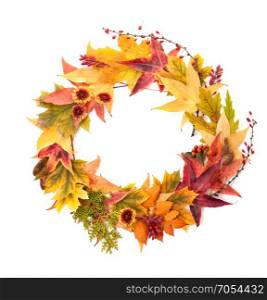 Autumn Concept: Wreath of Maple and Oak Leaves, Red Berries, Flowers and Pumpkins of Orange, Yellow and Red Colors on the White Background.