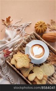 Autumn cozy composition. Cup of coffee, cookies on tray, yellow leaves.  Autumn, fall concept. Flat lay, top view.  