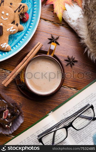 autumn cozy composition with coffe and book at wooden table. life style concept. flat lay