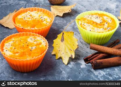 Autumn cupcake with pumpkin. Pumpkin muffins on a background with autumn leaves