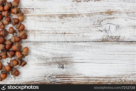 Autumn decorations with real acorns on white rustic wooden boards for Halloween or Thanksgiving holiday concept