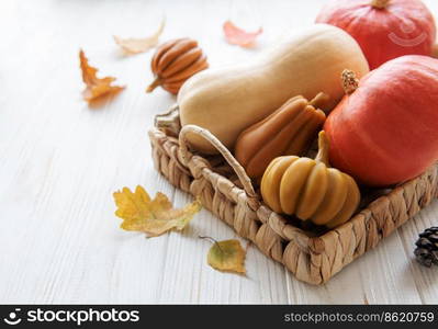 Autumn decorative pumpkins with fall leaves on wooden background. Thanksgiving or halloween holiday, harvest concept.