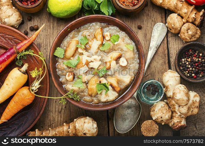 Autumn dietary artichoke cream soup.Soup of Jerusalem artichoke. Bowls with delicious artichoke soup