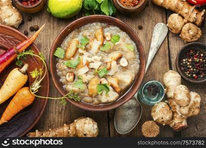 Autumn dietary artichoke cream soup.Soup of Jerusalem artichoke. Bowls with delicious artichoke soup