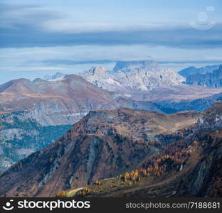 Autumn evening alpine Dolomites mountain scene near Pordoi Pass, Trentino, Italy. Picturesque traveling, seasonal, nature and countryside beauty concept scene.
