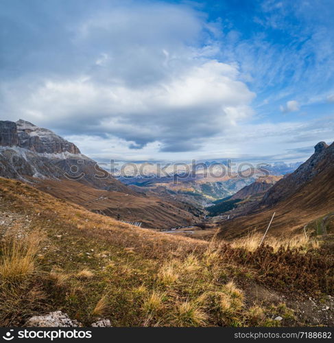 Autumn evening alpine Dolomites mountain scene near Pordoi Pass, Trentino, Italy. Picturesque traveling, seasonal, nature and countryside beauty concept scene.