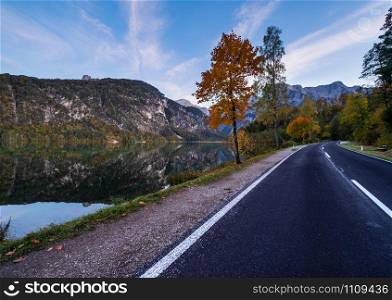 Autumn evening alpine view. Peaceful mountain lake with clear transparent water and reflections. Almsee lake, Upper Austria.