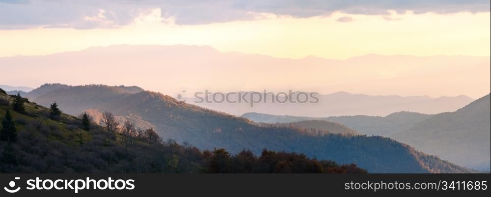Autumn evening plateau landscape with lust golden-pink sunlight on mountains and evening glow in sky. Two shots stitch image.