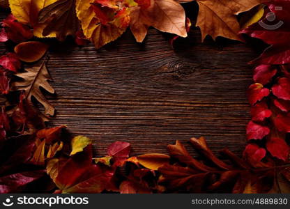 Autumn fall frame golden red leaves on wood background copy space