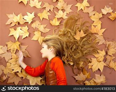 autumn fall little blond girl on dried tree leaves