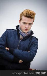 Autumn fashion. Young handsome man model casual style hair styling outdoor against overcast sky, cold autumnal foggy day