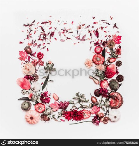 Autumn floral arrangement of fall flowers, leaves, little pumpkin other autumn objects of nature on white desk background. Made in shape of square. Frame ,Top view. Flat lay. Creative layout