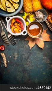 Autumn food with roasted vegetables and sauce, top view, copy space