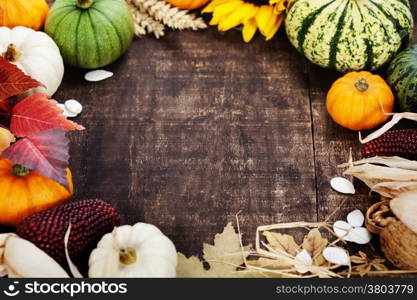 Autumn frame from pumpkins and corn on old wooden table. Thanksgiving day concept