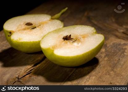 autumn fresh pears cutted in half over old wood board