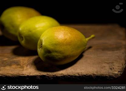 autumn fresh pears over old wood board
